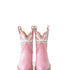 A pair of pink short boots with a bow on the top, made of full grain calfskin leather, with a stacked leather heel, Pink Western Cowgirl Boots, Heirloom Cowgirl Boots, Luxury Cowgirl Boots, Handcrafted Leather Boots