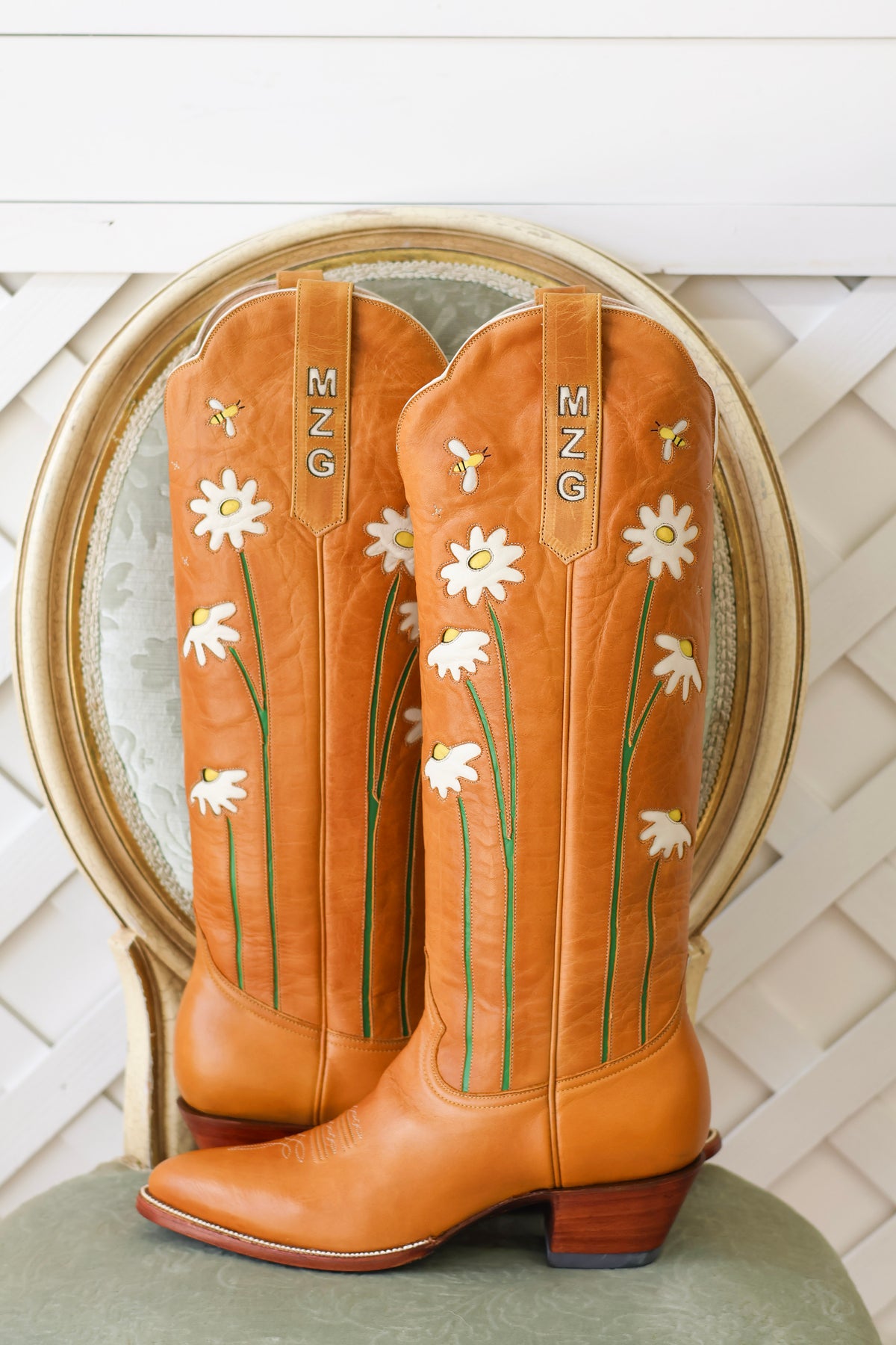 Tan Petite Paloma boots with white daisy embroidery and custom ear pulls personalized with MZG initials.